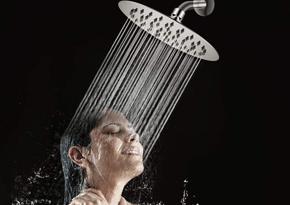 A woman showering with a rainfall shower head