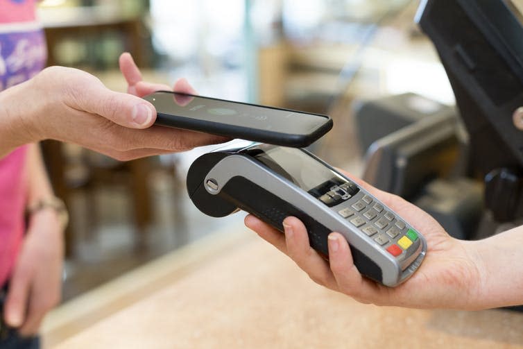 <span class="caption">Will Bitcoin become the payment system of the future?</span> <span class="attribution"><a class="link " href="https://www.shutterstock.com/image-photo/customer-paying-nfc-technology-271711736?src=nWcby-CzKFUCyzO2eTuNOA-1-3" rel="nofollow noopener" target="_blank" data-ylk="slk:s4visuals/Shutterstock;elm:context_link;itc:0;sec:content-canvas">s4visuals/Shutterstock</a></span>