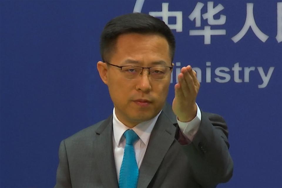 Chinese foreign ministry spokesperson Zhao Lijian gestures during a press conference on Wednesday, 6 July 2022 (AP)