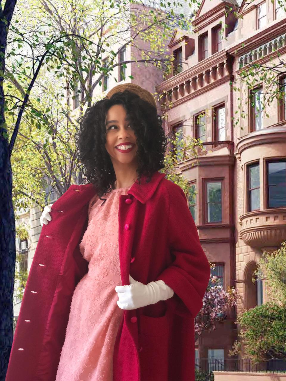 A person dressed up as Marvelous Mrs Maisel with townhouses and trees behind her