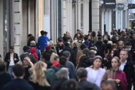 Shoppers, some wearing masks, walk along Oxford Street amidst the spread of the coronavirus disease (COVID-19) pandemic, in London