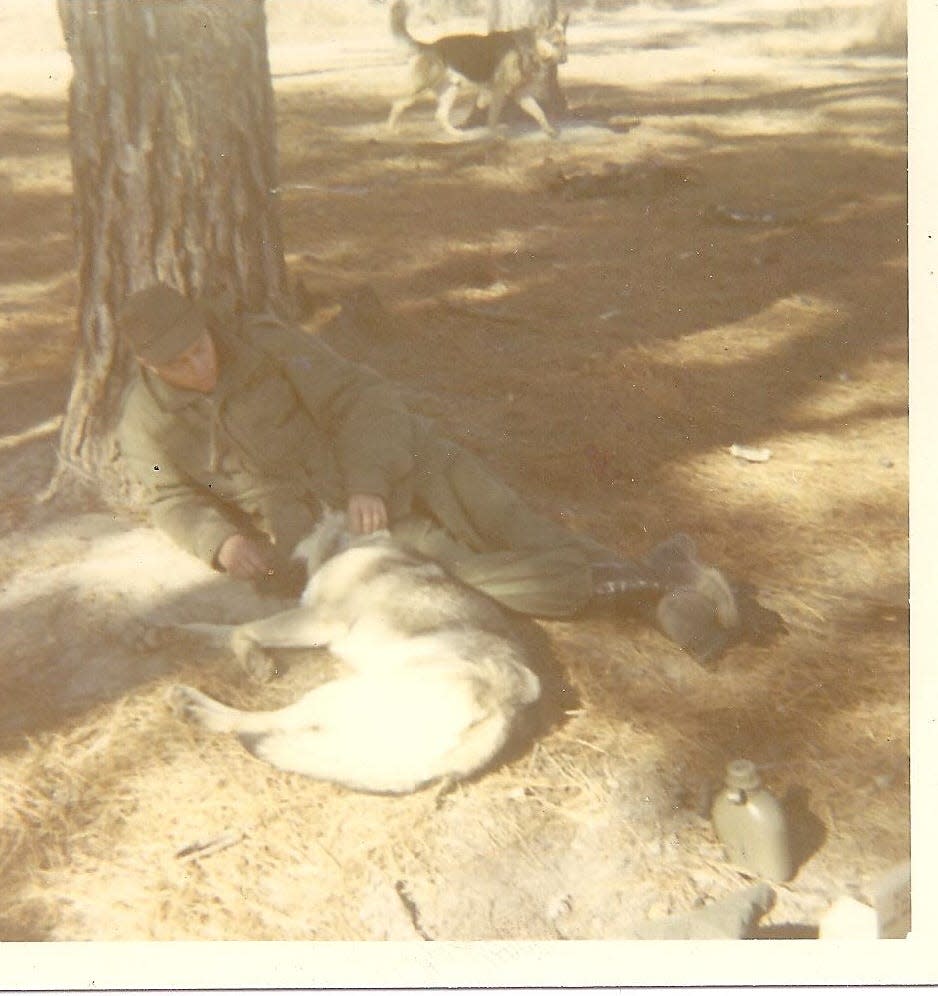 John Meeks rests with U.S. Army scout dog Gretchen at Fort Benning, Georgia, in 1969. Meeks trained with Gretchen to be a scout dog team, but when he got to Vietnam in 1970, he was assigned to a male dog named Artus. Gretchen was one of 204 dogs that were able to leave Vietnam at the end of the war. She was retrained to be a drug-sniffing dog for the U.S. Air Force in North Dakota until she developed hip dysplasia and was euthanized years later. Gretchen’s name is on the memorial wall at the Michigan War Dog Memorial cemetery.