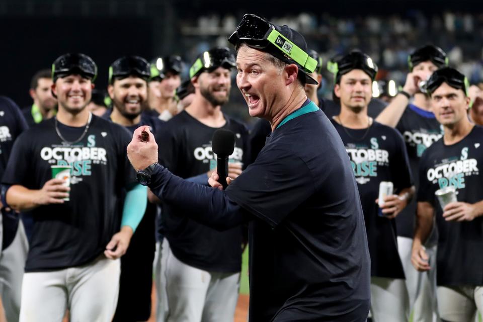 SEATTLE, WASHINGTON - SEPTEMBER 30: Manager Scott Servais #9 of the Seattle Mariners celebrates after clinching a postseason birth after beating the Oakland Athletics 2-1 at T-Mobile Park on September 30, 2022 in Seattle, Washington. The Seattle Mariners have clinched a postseason appearance for the first time  in 21 years, the longest playoff drought in North American professional sports. (Photo by Steph Chambers/Getty Images)