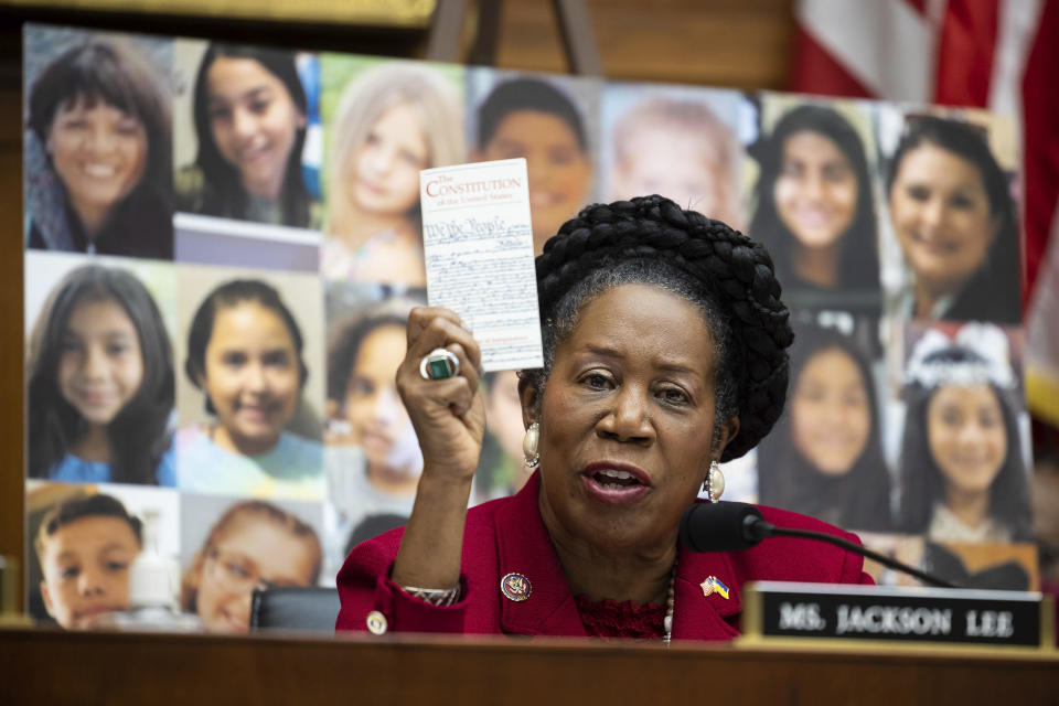 Rep. Sheila Jackson Lee holds a copy of the U.S. Constitution as she speaks in front of photos of victims of the recent Uvalde, Texas, mass school shooting during a House Judiciary Committee markup on gun control legislation on June 2, 2022. / Credit: Francis Chung/E&E News/POLITICO via AP Images