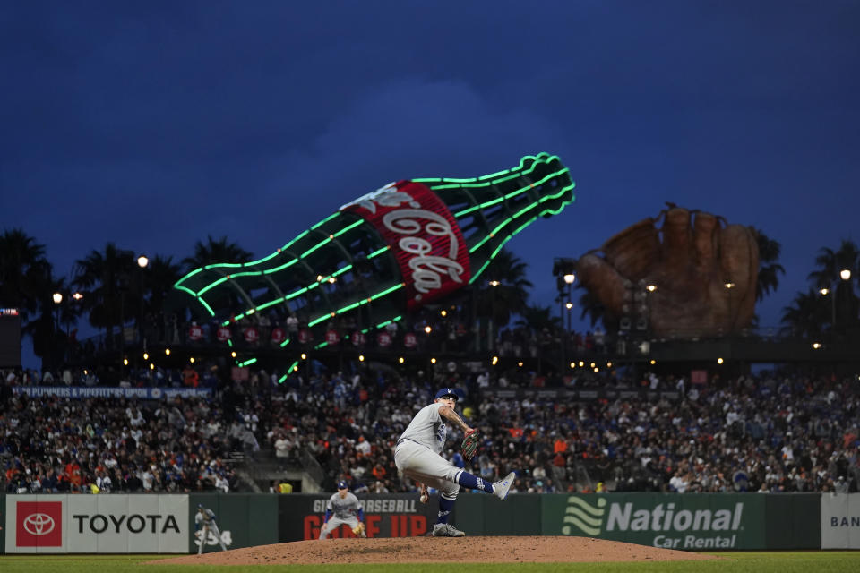 Los Angeles Dodgers' Julio Urias, bottom, pitches against the San Francisco Giants during the third inning of a baseball game in San Francisco, Saturday, Sept. 17, 2022. (AP Photo/Jeff Chiu)