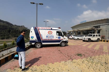 An ambulance is parked outside an airport where the bodies of missing climbers are expected to arrive in Pithoragarh