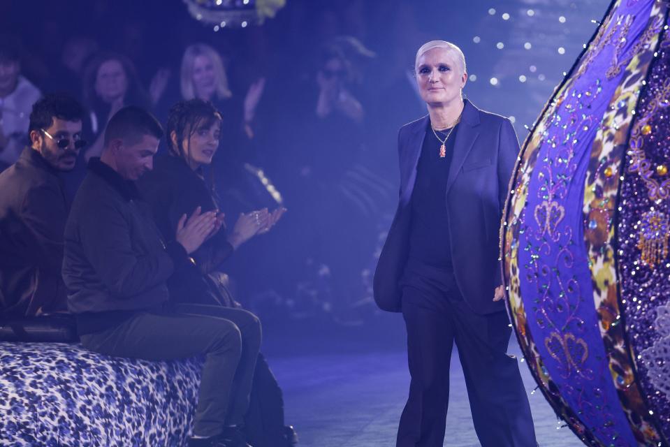 Designer Maria Grazia Chiuri accepts applause at the conclusion of the Christian Dior Fall/Winter 2023-2024 ready-to-wear collection presented Tuesday, Feb. 28, 2023 in Paris. (Vianney Le Caer/Invision/AP)