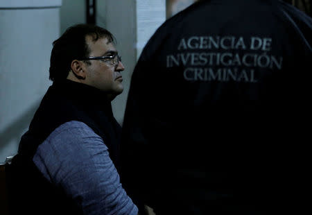 Former governor of Mexican state Veracruz Javier Duarte (L) sits at a police station after he was detained in a hotel in Panajachel, Guatemala April 15, 2017. The writing on the jacket reads "Criminal investigation agency". REUTERS/Danilo Ramirez