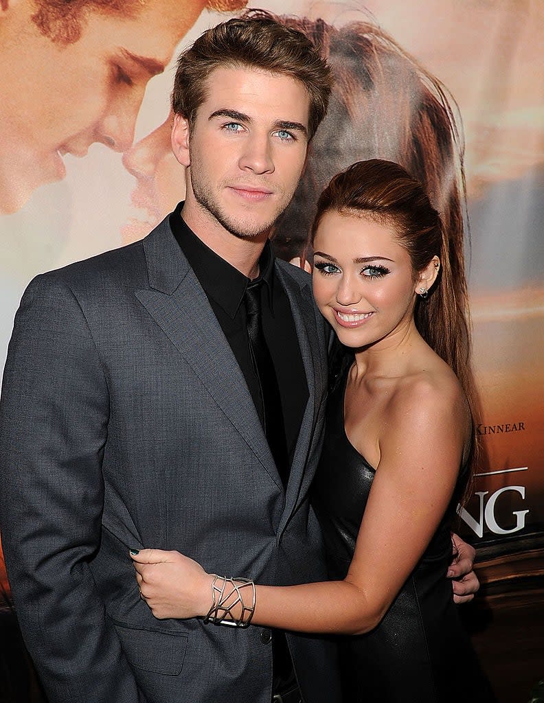 Actor Liam Hemsworth (L) and actress/singer Miley Cyrus arrive at the premiere of Touchstone Picture's 