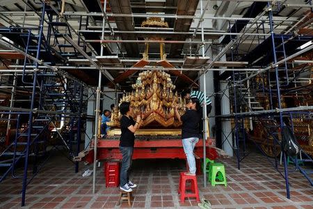 Thai officials from the Conservation Science Division of the Fine Arts Department of the National Museum of Thailand repairs the Minor Chariot, which will be used during the late King Bhumibol Adulyadej's funeral later this year, Thailand, February 6, 2017. REUTERS/Chaiwat Subprasom