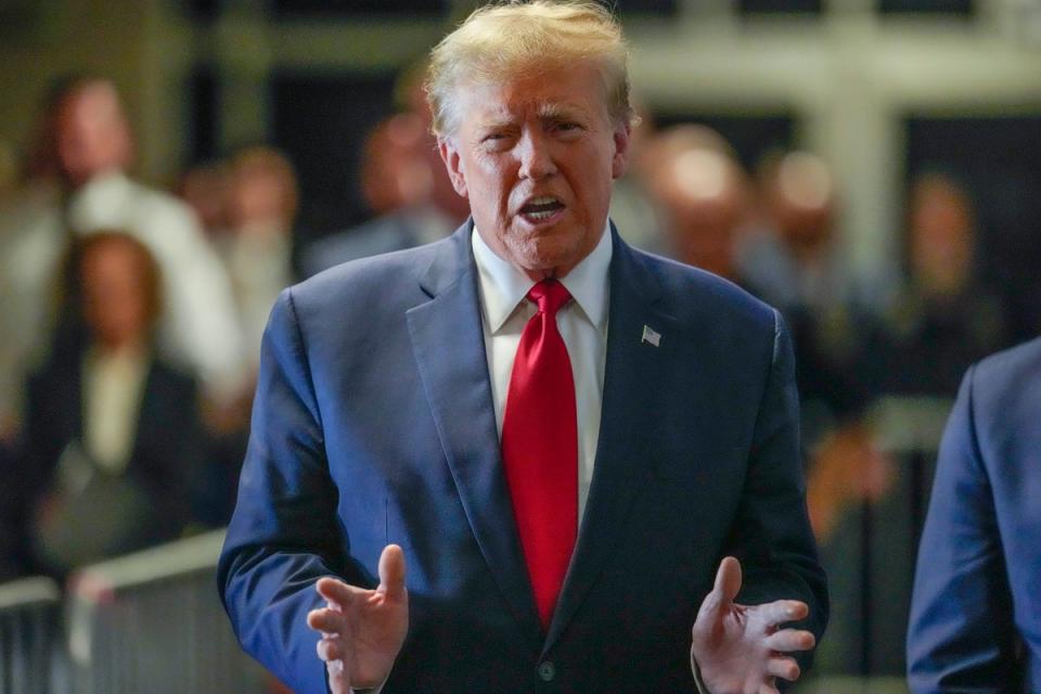 Donald Trump speaks to reporters as he arrives at Manhattan criminal court on 15 February. (AP)