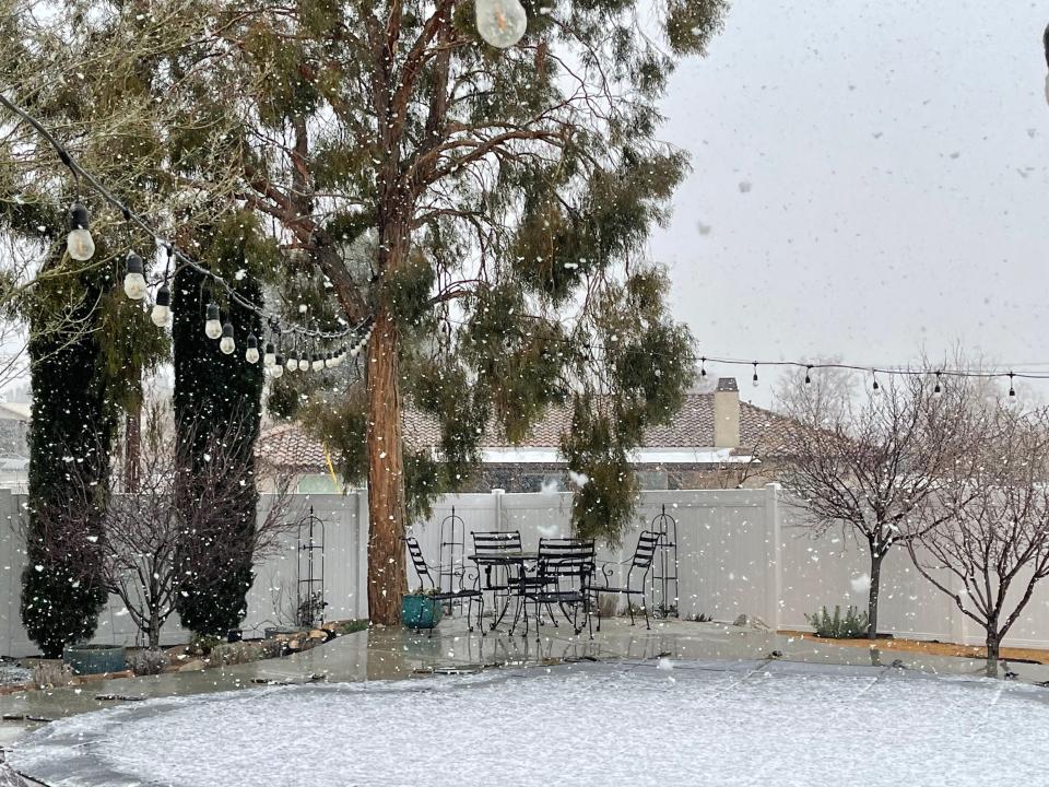A brief snow flurry passes through Apple Valley resident Sam Atalla's backyard, marking a rare winter phenomenon for Southern California's High Desert folks on Thursday, Feb. 23.