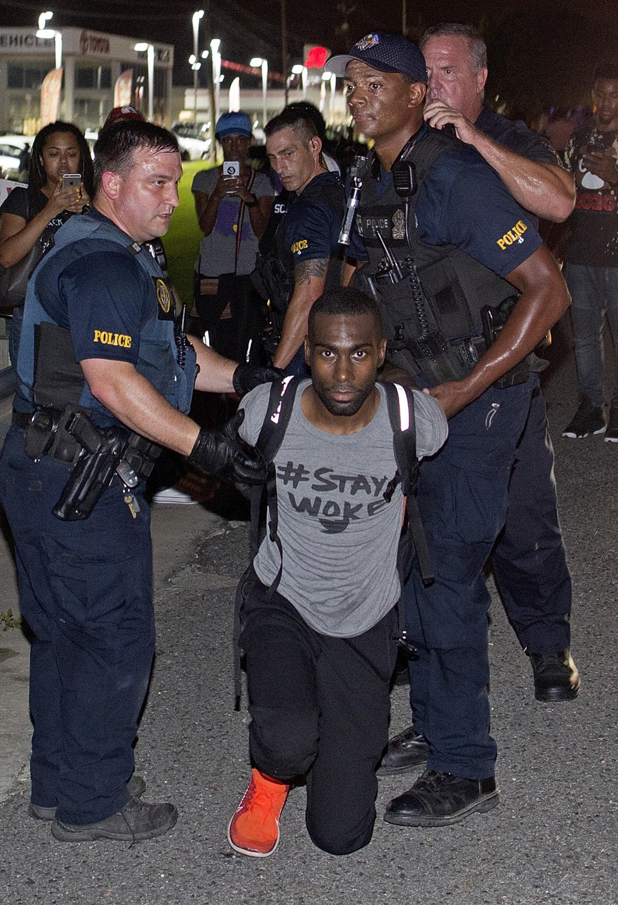 Police officers arrest activist DeRay McKesson during a protest along Airline Highway, a major road that passes in front of the Baton Rouge Police Department headquarters Saturday, July 9, 2016, in Baton Rouge, La. Protesters angry over the fatal shooting of Alton Sterling by two white Baton Rouge police officers rallied Saturday at the convenience store where he was shot, in front of the city's police department and at the state Capitol for another day of demonstrations. (AP Photo/Max Becherer)