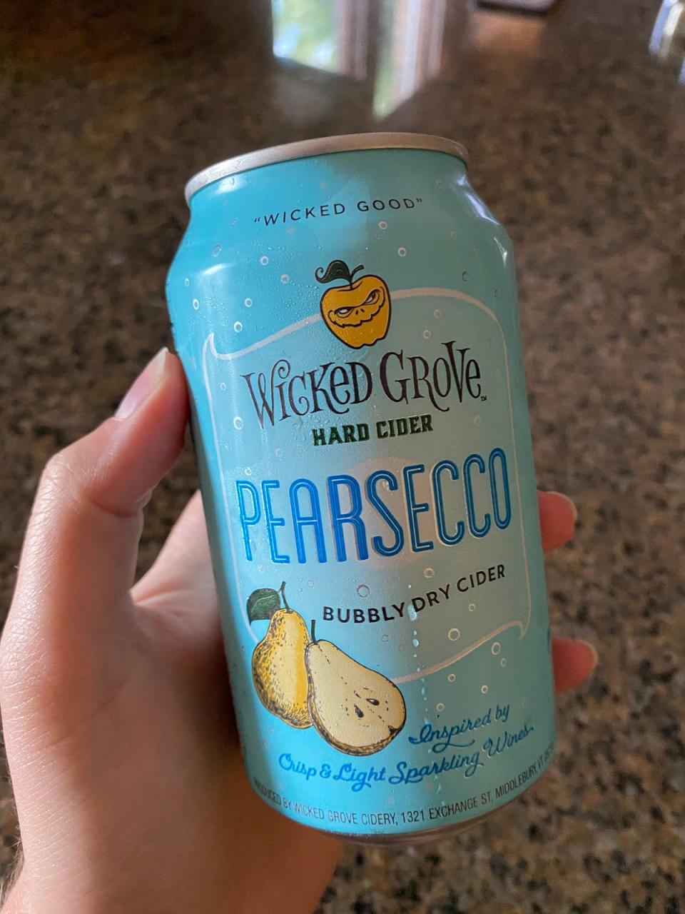 hand holding can of aldi brand pearsecco cider