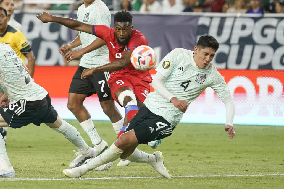 Haiti's Duckens Nazon (9) shoots against Mexico's Edson Alvarez (4) during the first half of a CONCACAF Gold Cup soccer match Thursday, June 29, 2023, in Glendale, Ariz. (AP Photo/Darryl Webb)