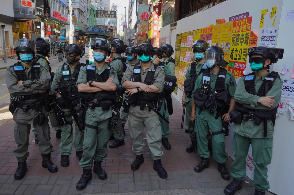 Police officers stand guard as people gather during a pro-democracy rally supporting human rights and to protest against Beijing's national security law in Hong Kong, Sunday, June 28, 2020. (AP Photo/Vincent Yu)