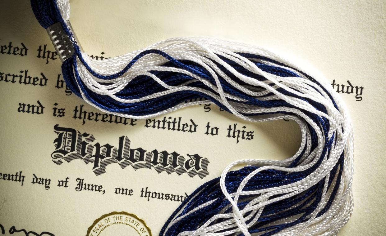 Diploma and tassel shot from above.  Concept for graduation.