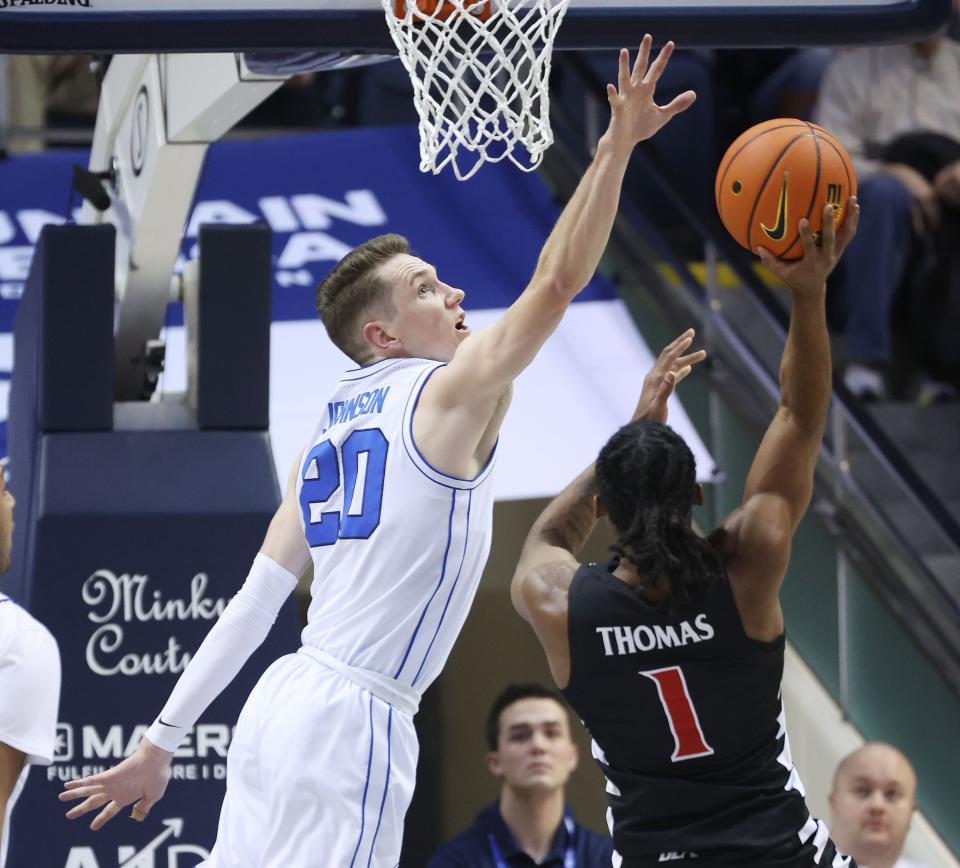 Brigham Young Cougars guard Spencer Johnson (20) tries to block the shot by Cincinnati Bearcats guard Day Day Thomas (1) in Provo on Saturday, Jan. 6, 2024. Cincinnati won 71-60. | Jeffrey D. Allred, Deseret News