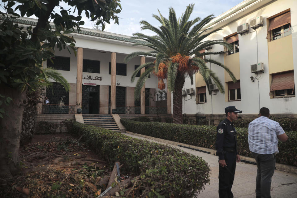 Guards stand outside court where journalist Hajar Rissouni was delivered a one year prison sentence on accusations of her undergoing an illegal abortion, in Rabat, Morocco, Monday, Sept. 30, 2019. The 28-year old Moroccan journalist Hajar Raissouni was sentenced to one year in prison, Monday, while her fiancé also received a one-year sentence and the doctor accused of terminating the pregnancy was sentenced to two years in jail and suspended from practicing. (AP Photo/Mosa'ab Elshamy)