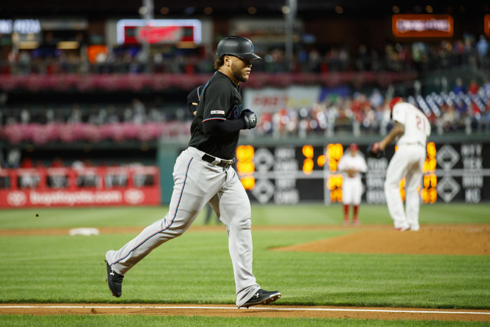 Miami Marlins' Harold Ramirez, left, rounds the bases after hitting a home run off Philadelphia Phillies starting pitcher Vince Velasquez during the second inning of a baseball game, Friday, Sept. 27, 2019, in Philadelphia. (AP Photo/Matt Slocum)