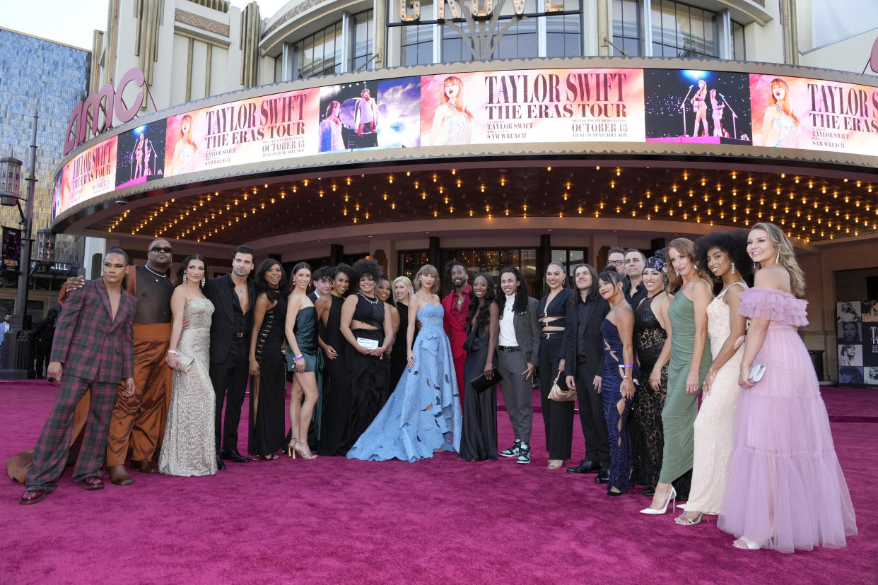 Taylor Swift, center, and tour dancers arrive at the world premiere of the concert film 