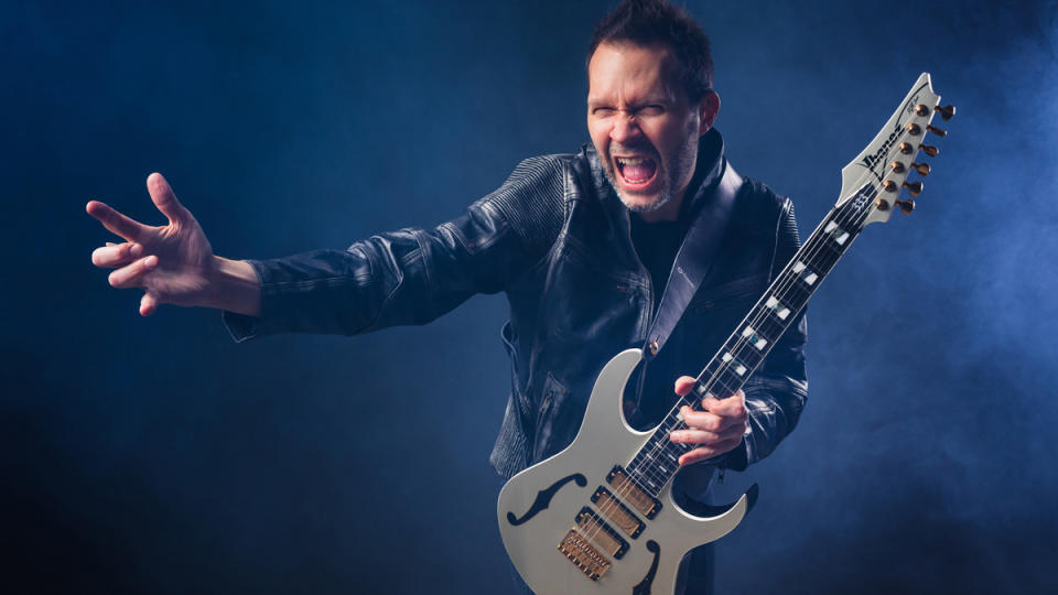 Paul Gilbert reaching out towards the camera