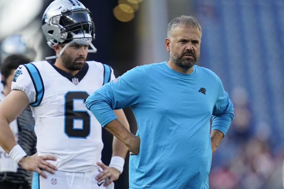 Carolina Panthers quarterback Baker Mayfield (6) and head coach Matt Rhule on the field prior to a preseason NFL football game against the New England Patriots, Friday, Aug. 19, 2022, in Foxborough, Mass. (AP Photo/Charles Krupa)