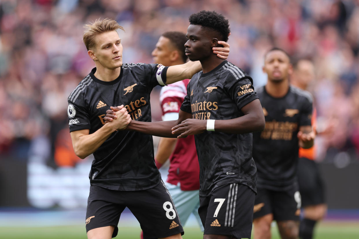 Arsenal midfielder Martin Odegaard (left) consoles teammate Bukayo Saka after his penalty miss during their English Premier League match against West Ham United.