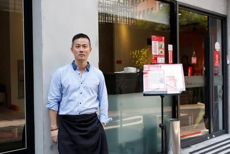 Chris Lee, a migrant from Hong Kong, poses at his restaurant in Taipei, Taiwan July 15, 2016. Picture taken July 15, 2016. REUTERS/Tyrone Siu