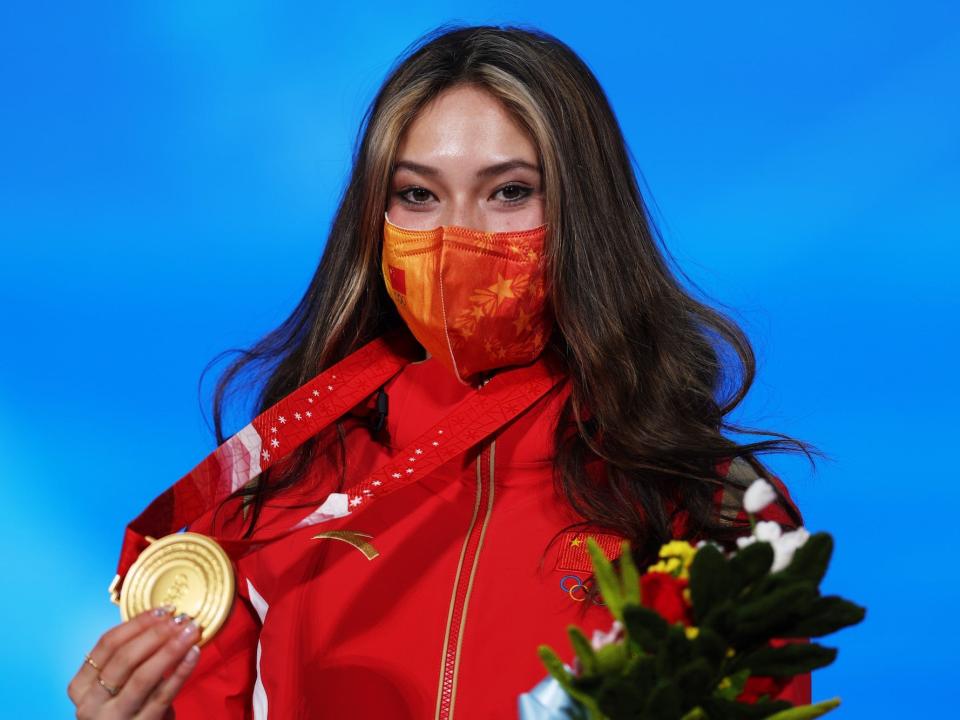 Gold medallist Ailing Eileen Gu of Team China celebrates with their medal during the Women's Freestyle Skiing Freeski Big Air medal ceremony on Day 4 of the Beijing 2022 Winter Olympic Games at Beijing Medal Plaza