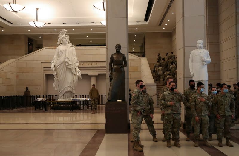 Members of the U.S. National Guard wait to take tours of the U.S. Capitol building in Washington