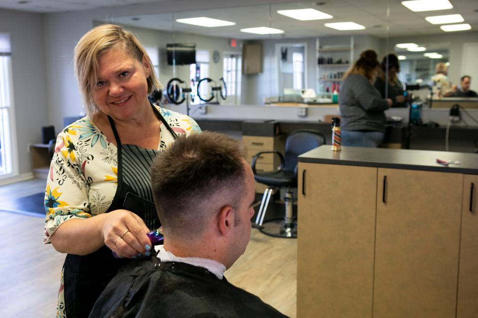 Rebecca Slater cuts the hair of Alan Paulk inside of her barber and beauty shop called "Rebecca's Barber N Beauty" on North Memorial Drive on July 31, 2023 in Lancaster, Ohio.