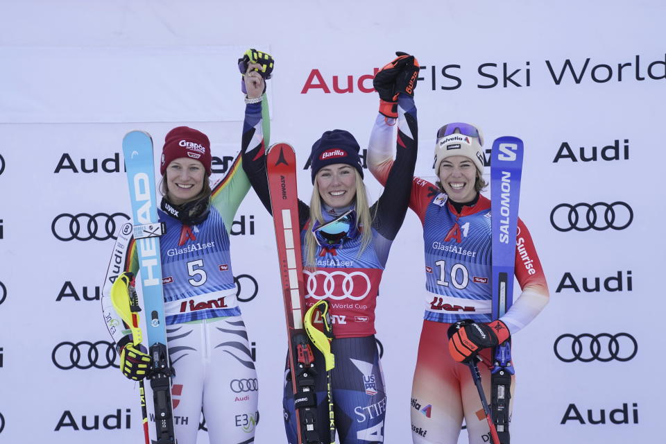 From left, second placed Germany's Lena Duerr, the winner United States' Mikaela Shiffrin and third placed Switzerland's Michelle Gisin celebrate after an alpine ski, women's World Cup slalom race, in Lienz, Austria, Friday, Dec. 29, 2023. (AP Photo/Giovanni Auletta)