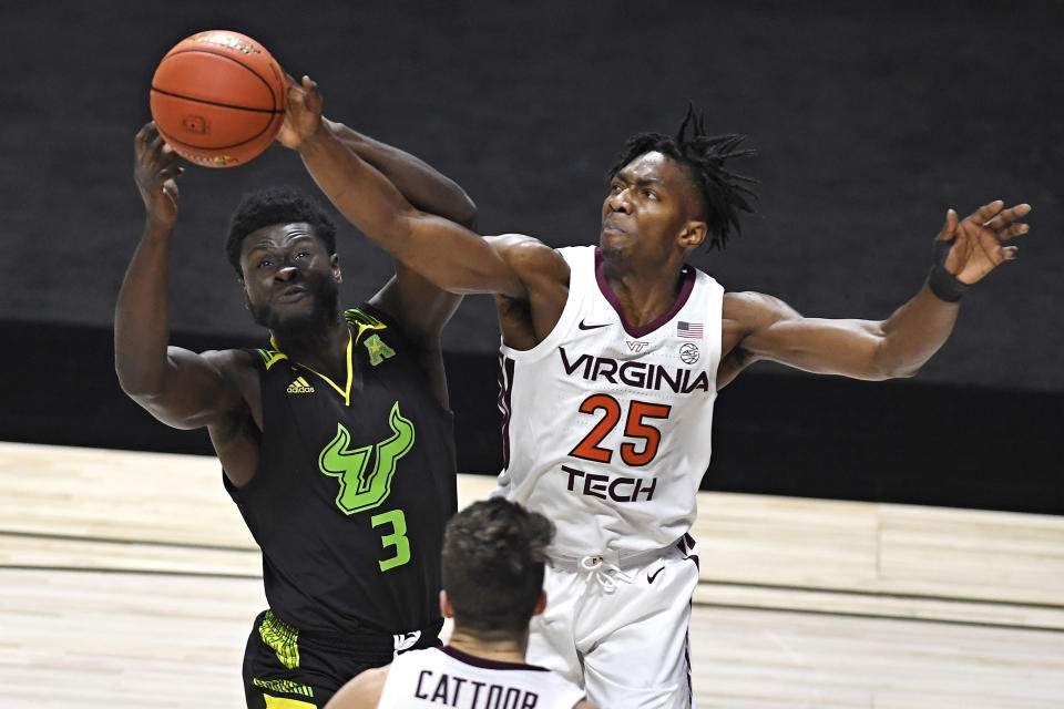 South Florida's Prince Oduro, left, and Virginia Tech's Justyn Mutts reach for the ball in the first half of an NCAA college basketball game, Sunday, Nov. 29, 2020, in Uncasville, Conn. (AP Photo/Jessica Hill)