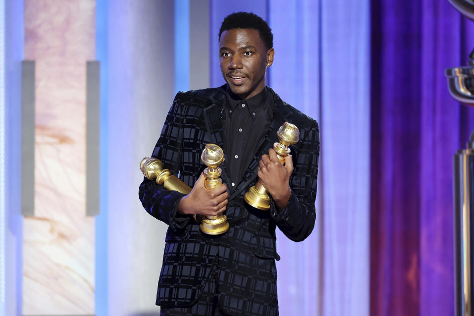This image released by NBC shows host Jerrod Carmichael holding three Golden Globes during the 80th Annual Golden Globe Awards at the Beverly Hilton Hotel on Tuesday, Jan. 10, 2023, in Beverly Hills, Calif. (Rich Polk/NBC via AP)