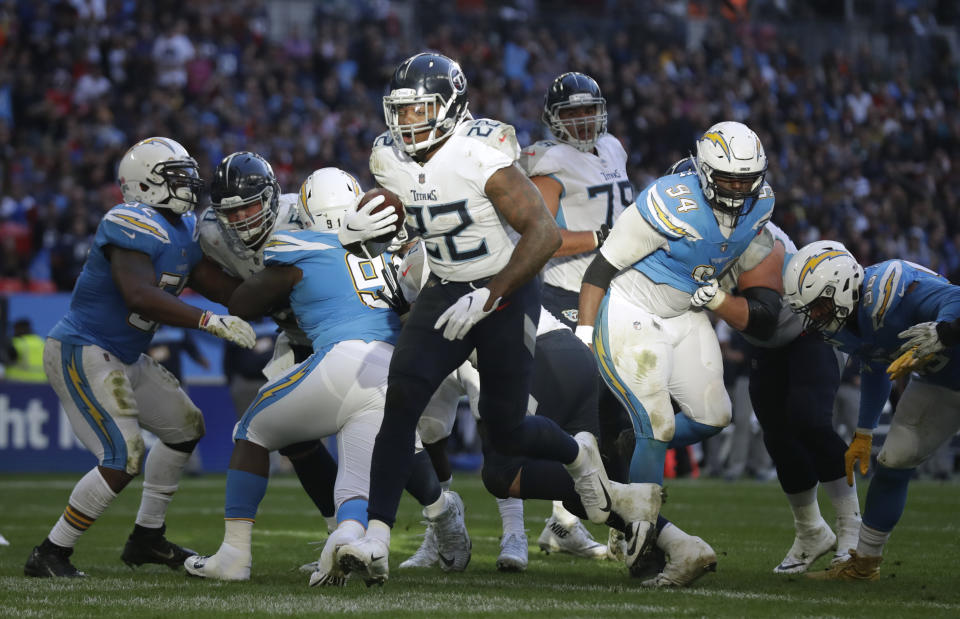 Tennessee Titans running back Derrick Henry (22) runs through to score a touchdown during the first half of an NFL football game against Los Angeles Chargers at Wembley stadium in London, Sunday, Oct. 21, 2018. (AP Photo/Matt Dunham)