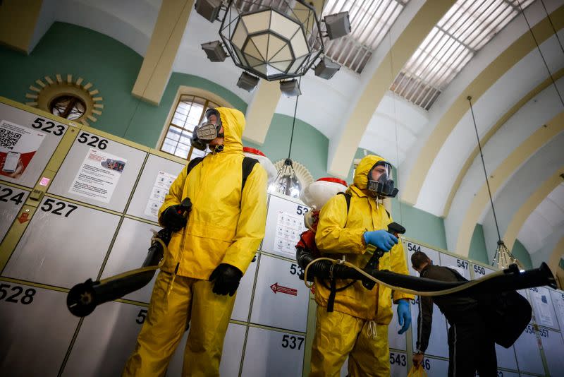 FILE PHOTO: Specialists sanitize a railway station amid the outbreak of the coronavirus disease in Moscow