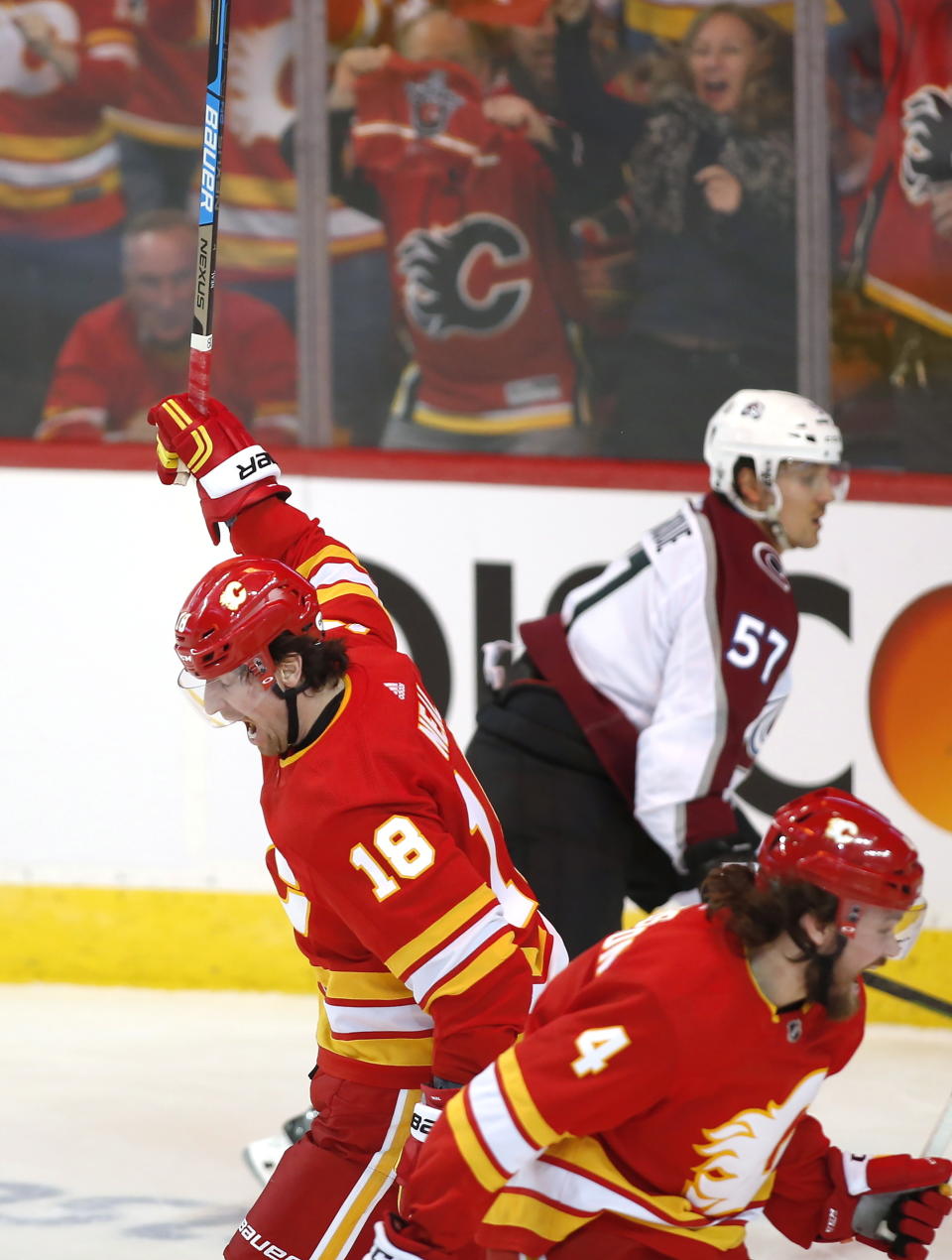 Calgary Flames defenseman Rasmus Andersson (4) celebrates his power-play goal against the Colorado Avalanche with left wing James Neal (18) during the second period of Game 2 of an NHL hockey first-round playoff series Saturday, April 13, 2019, in Calgary, Alberta. (Jeff McIntosh/The Canadian Press via AP)