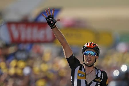 MTN-Qhubeka rider Stephen Cummings of Britain celebrates as he crosses the finish line to win the 178.5-km (110.9 miles) 14th stage of the 102nd Tour de France cycling race from Rodez to Mende, France, July 18, 2015. REUTERS/Benoit Tessier