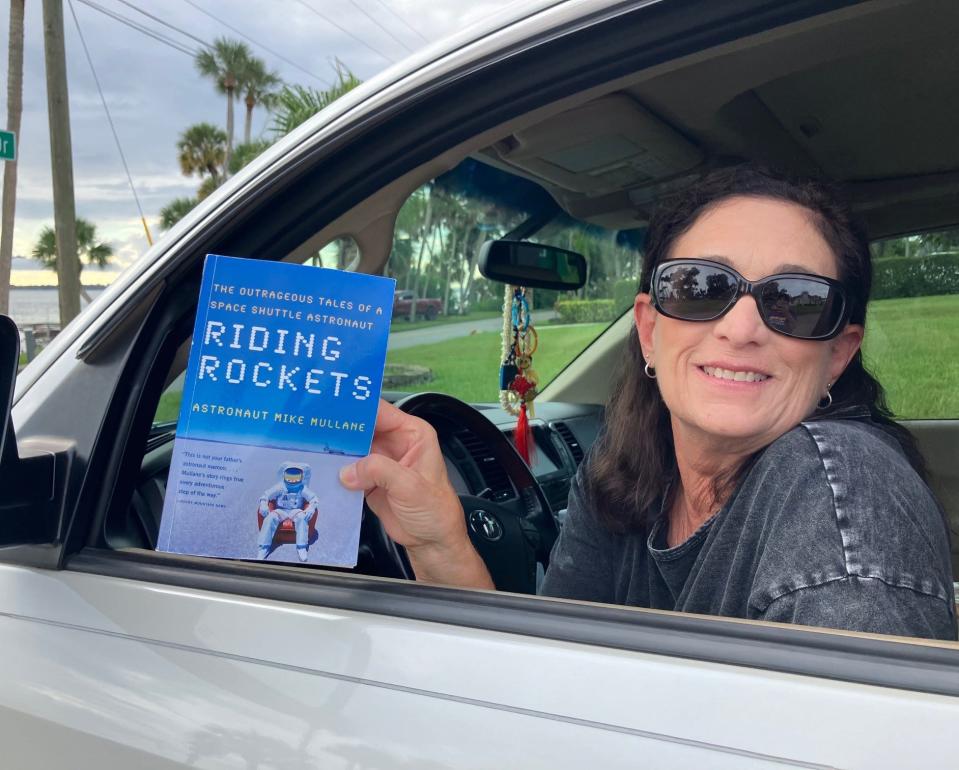 Dina Franklin brought along some reading material to kill time while waiting along the banks of  the Indian River in Cocoa to watch the Artemis I launch.