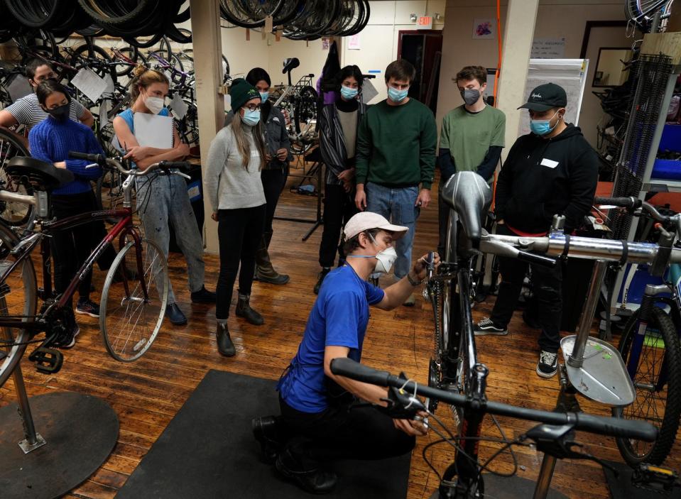 Students in a bike maintenance class at the Providence Bike Collective follow instructor John "Rosy" Rosenwinkel as he helps them understand bike derailleurs during their weekly bike class.