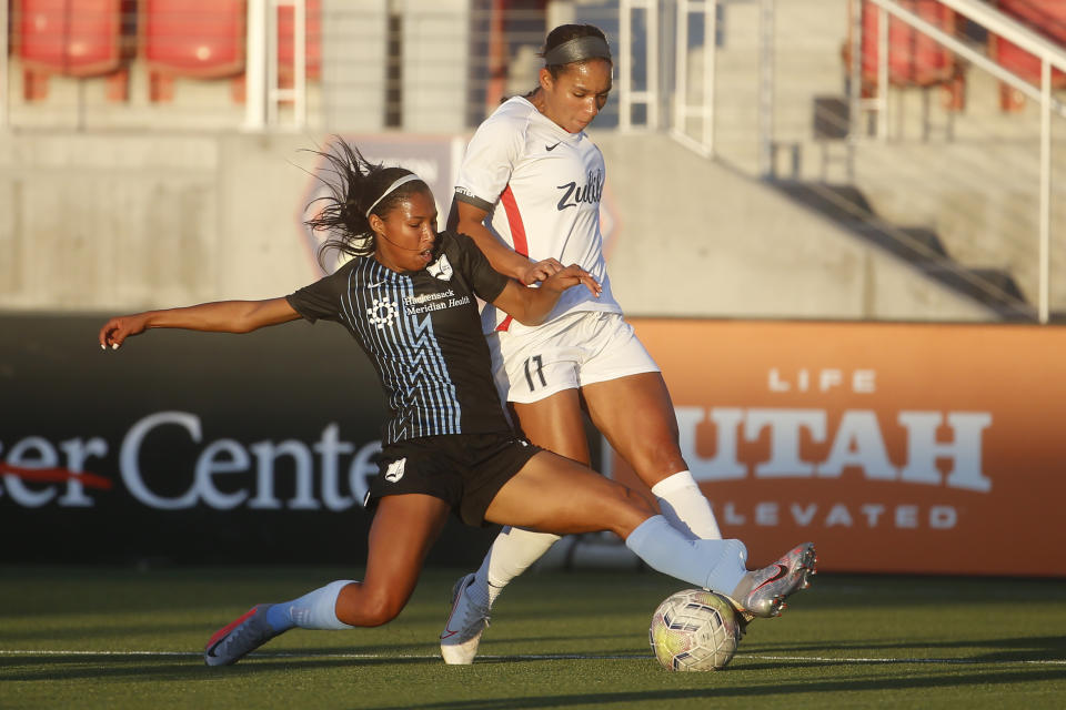 Sky Blue FC forward Midge Purce, left, and OL Reign forward Darian Jenkins (11) vie for the ball during the first half of an NWSL Challenge Cup soccer match at Zions Bank Stadium on Tuesday, June 30, 2020, in Herriman, Utah. (AP Photo/Rick Bowmer)