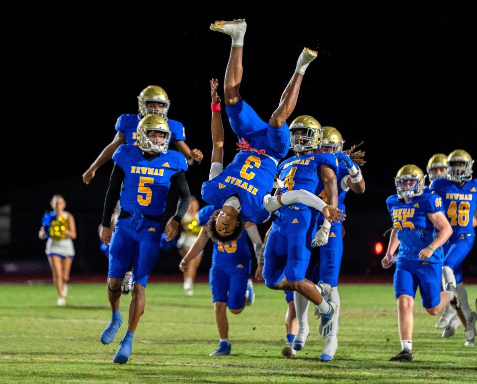 Cardinal Newman wide receiver Naeshaun Montgomery flips as they take the field against Benjamin in their regional semifinal playoff football game in West Palm Beach on November 17, 2023.