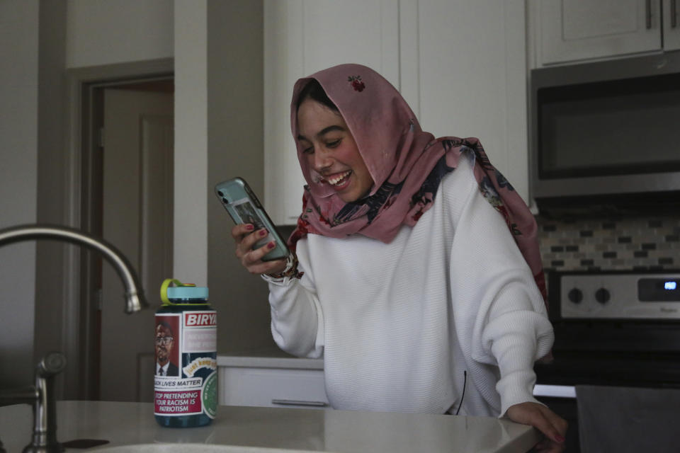 Amirah Ahmed, 17, video chats with a friend from her home in Fredericksburg, Va., on Saturday, Aug. 14, 2021. (AP Photo/Jessie Wardarski)