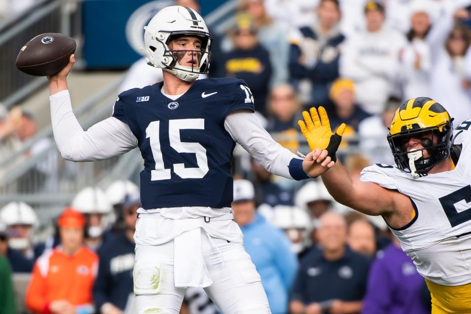 Penn State quarterback Drew Allar (15) throws under pressure from Michigan's Mason Graham in the first half of an NCAA football game at Beaver Stadium Saturday, Nov. 11, 2023, in State College, Pa.