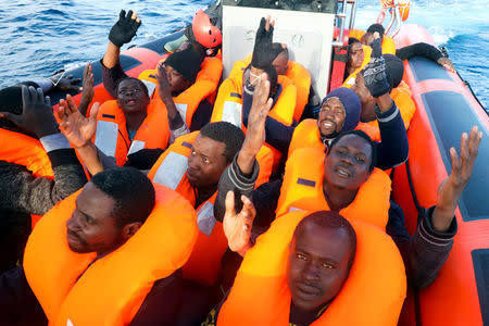 Sub-Saharan migrants pray after being rescued by members of the Spanish NGO Proactiva Open Arms. REUTERS/Giorgos Moutafis