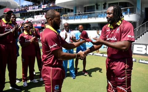 Chris Gayle of the West Indies presents John Campbell with his ODI cap - Credit: GETTY IMAGES