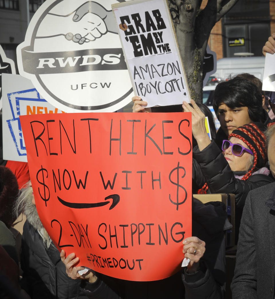 In this Nov. 14, 2018 file photo, protesters carry anti-Amazon signs during a coalition rally and press conference of elected officials, community organizations and unions opposing Amazon headquarters getting subsidies to locate in the New York neighborhood of Long Island City, the Queens borough of New York. Opposition to the retail giant coming to Long Island City by local politicians, some unions and residents of the community fearing the retail giant's presence will raise the cost of living was almost immediate. (AP Photo/Bebeto Matthews, File)