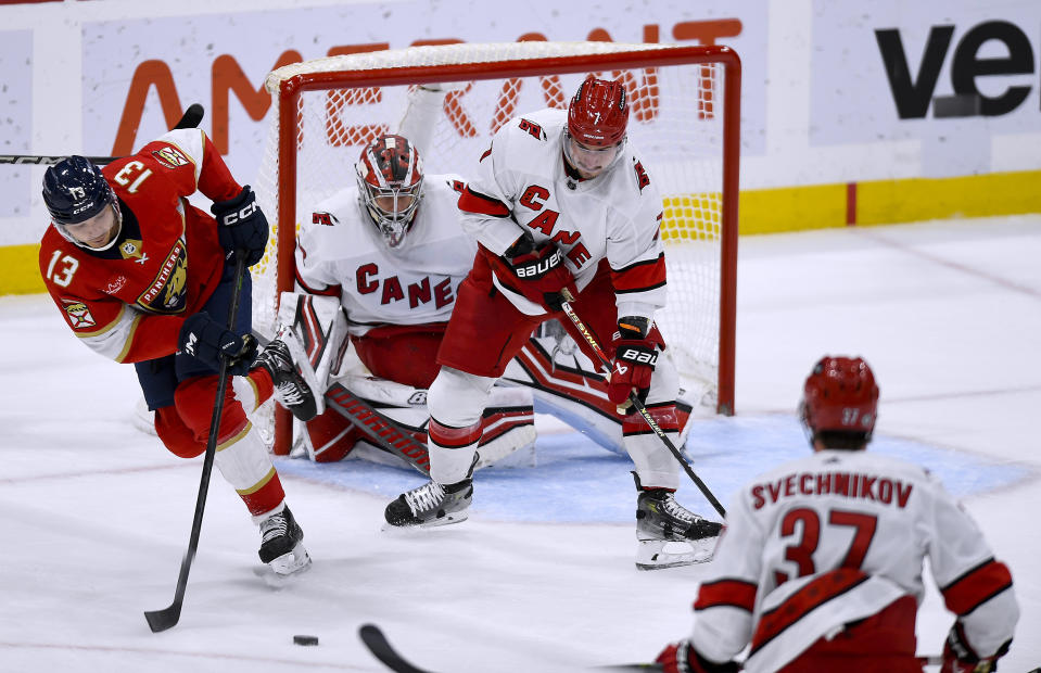 Florida Panthers center Sam Reinhart (13) controls the puck in front of the Carolina Hurricanes goal during the first period of an NHL hockey game Friday, Nov. 10, 2023, in Sunrise, Fla. (AP Photo/Michael Laughlin)