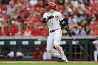 Cincinnati Reds' Nick Castellanos watches as he hits an RBI-sacrifice fly during the first inning of a baseball game against the Atlanta Braves in Cincinnati, Thursday, June 24, 2021. (AP Photo/Aaron Doster)
